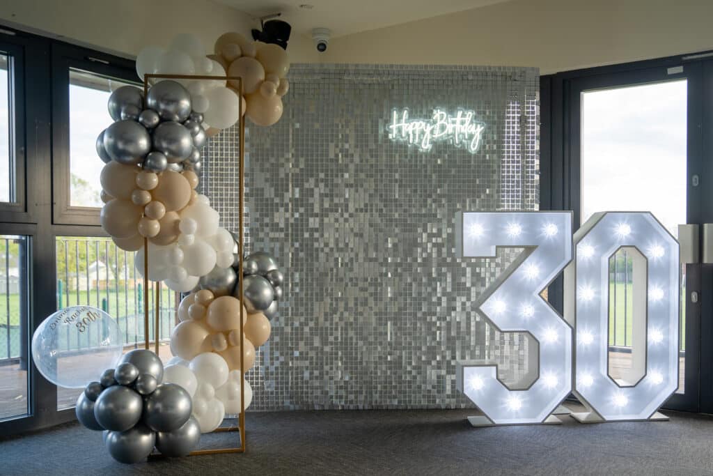 Our 4ft light-up 30 numbers beside the party styling at Emma and Rach’s twin 30th birthday party