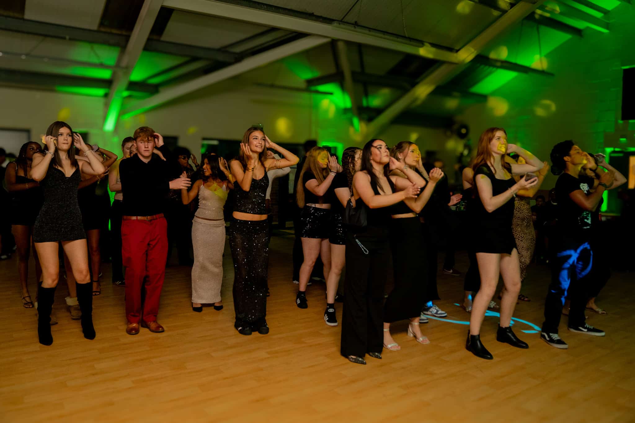 The dance floor under green lighting at a party