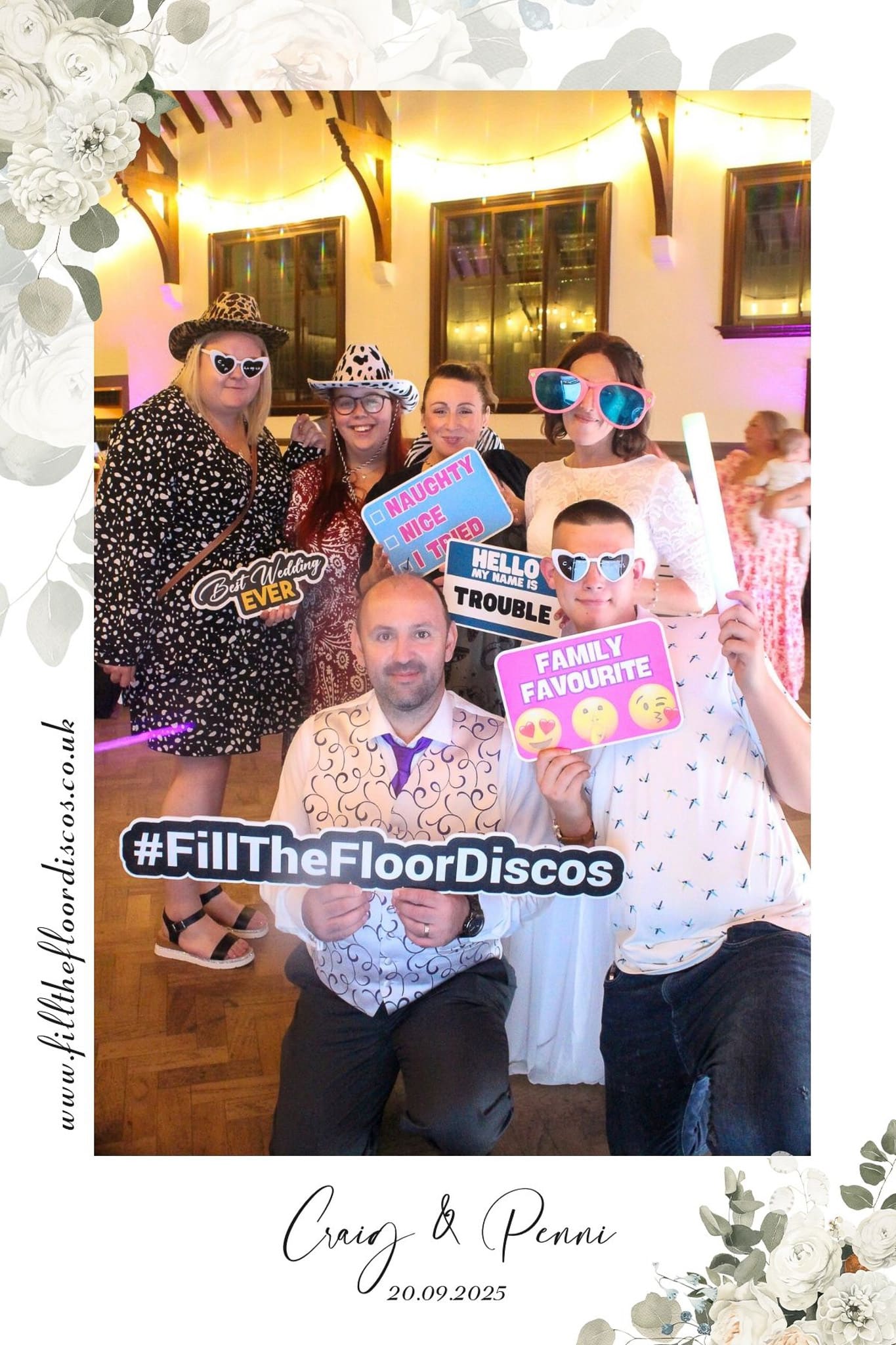 Wedding guests loaded with props in the photo booth