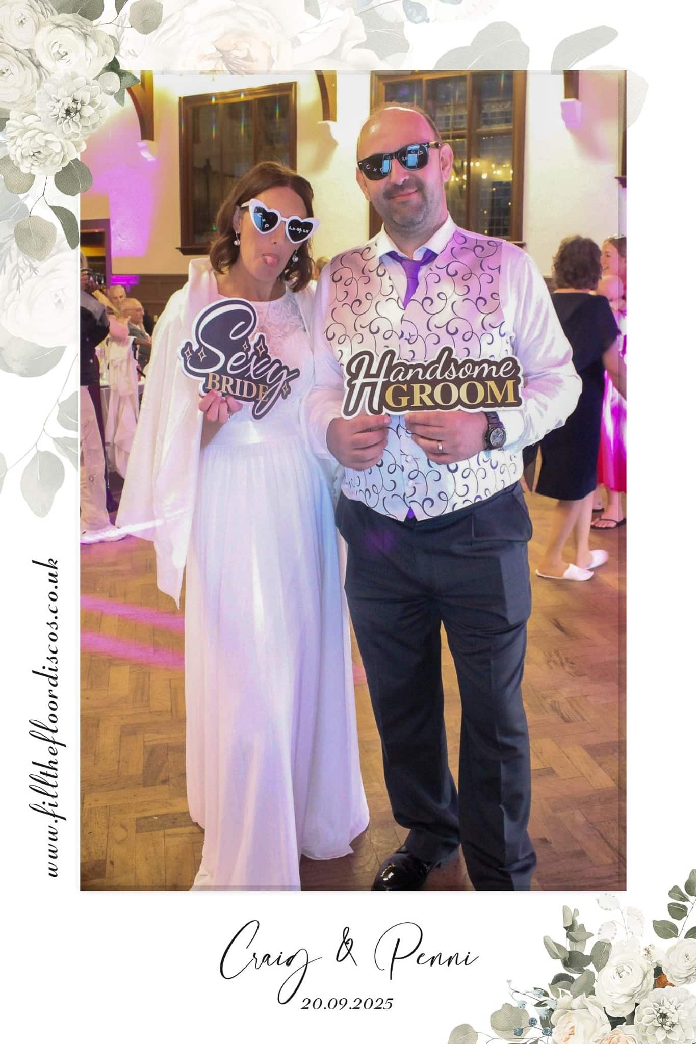 Penni and Craig with fun signs in the photo booth at their wedding