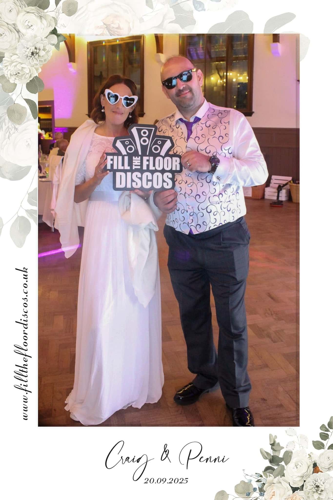 The newlyweds with a Fill The Floor Discos sign in the photo booth