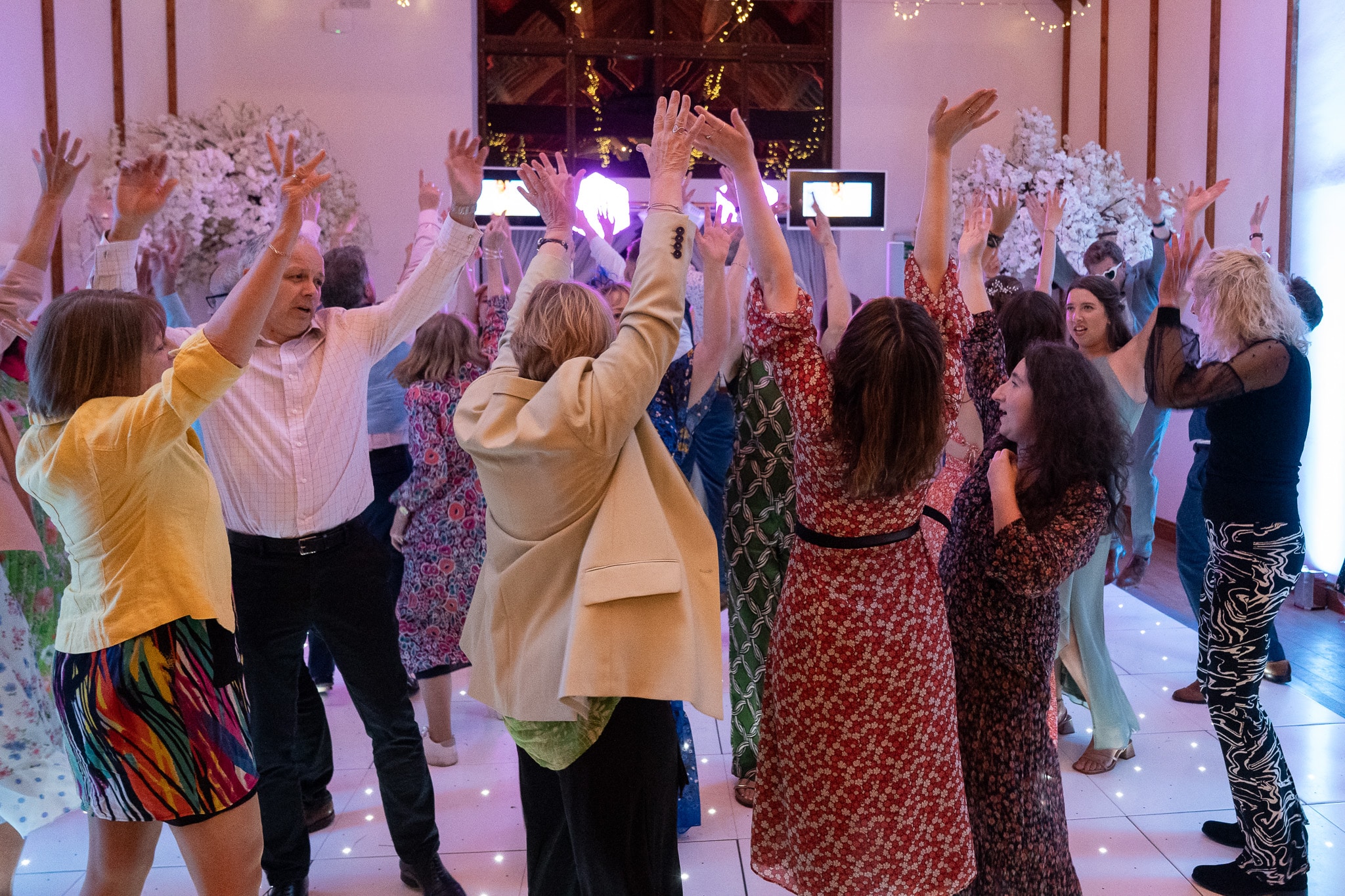 When to book your wedding DJ — a packed dance floor at Winters Tale Country Barn with LED star-lit dance floor and DJ booth