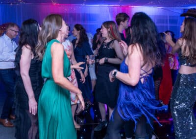 Friends dancing together at a 60th birthday disco in Amersham
