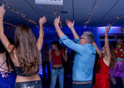 Disco hire Amersham – guests with hands in the air at Nicola's 60th birthday at Amersham & Chiltern Rugby Club