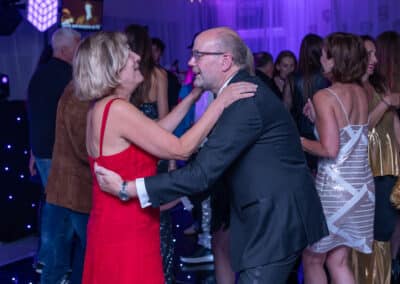 Couple dancing closely at a 60th birthday disco at Amersham & Chiltern Rugby Club