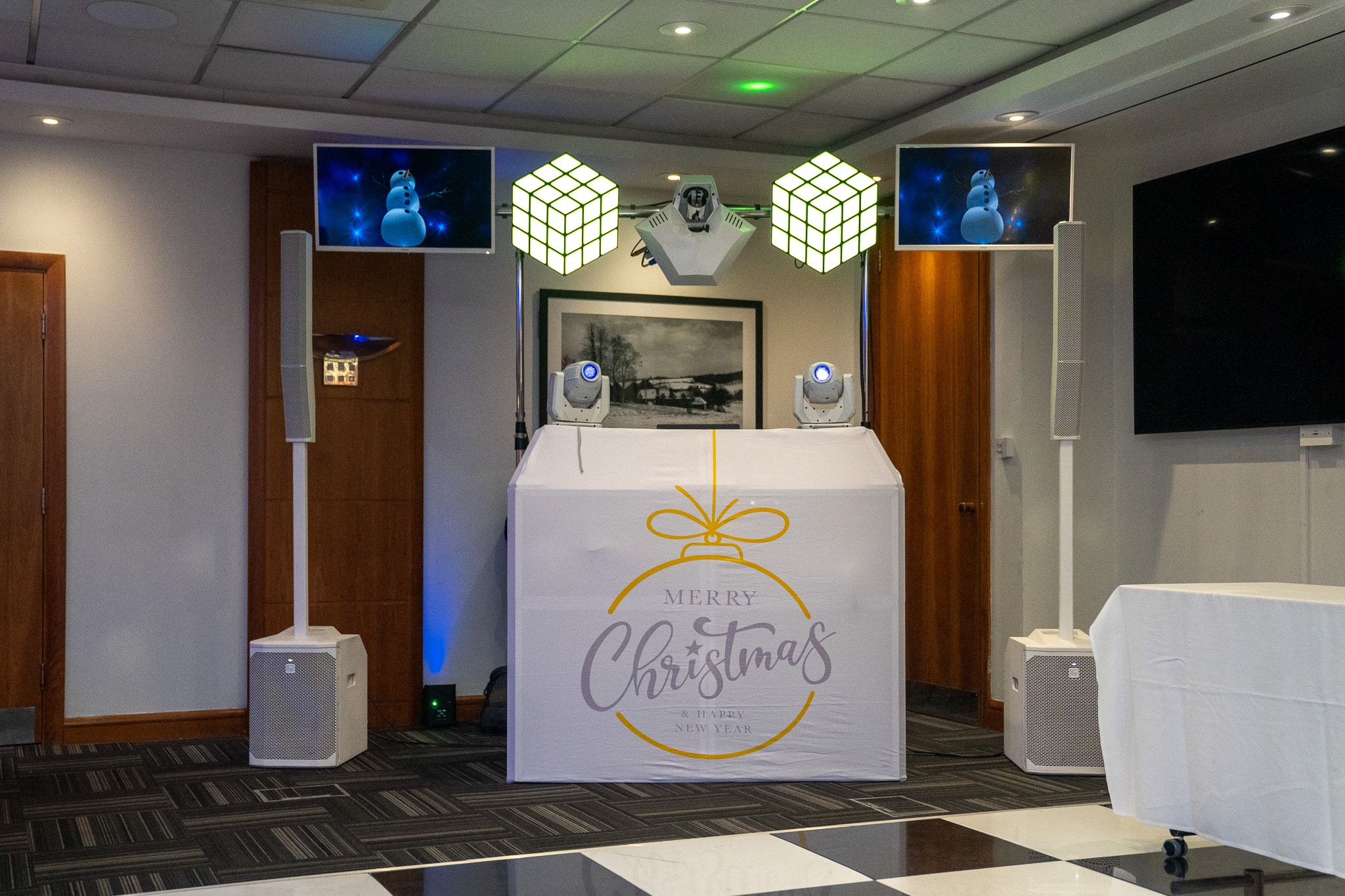 White Christmas party disco setup with festive DJ booth
