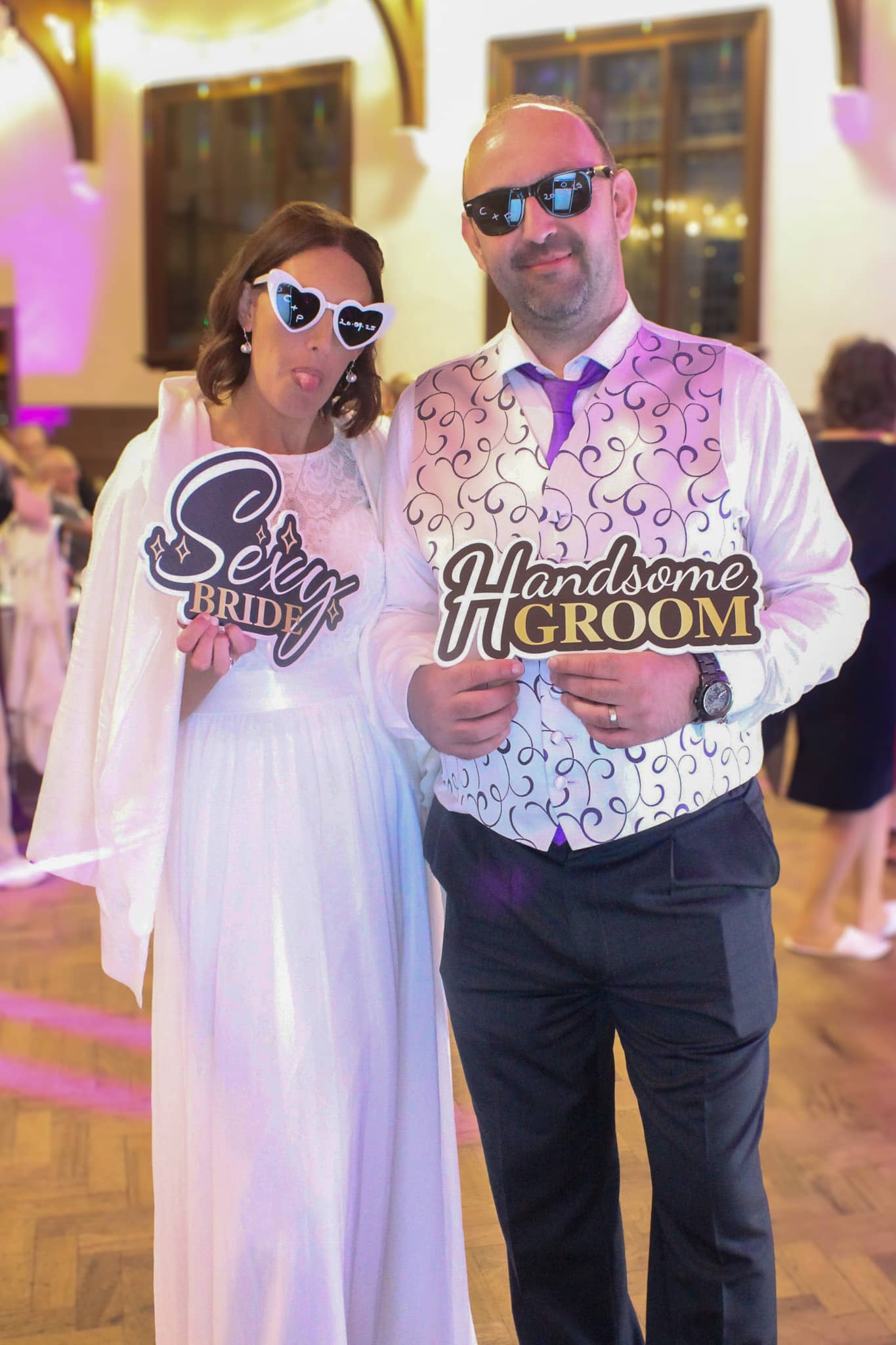 Couple with sexy bride and handsome groom photo booth props
