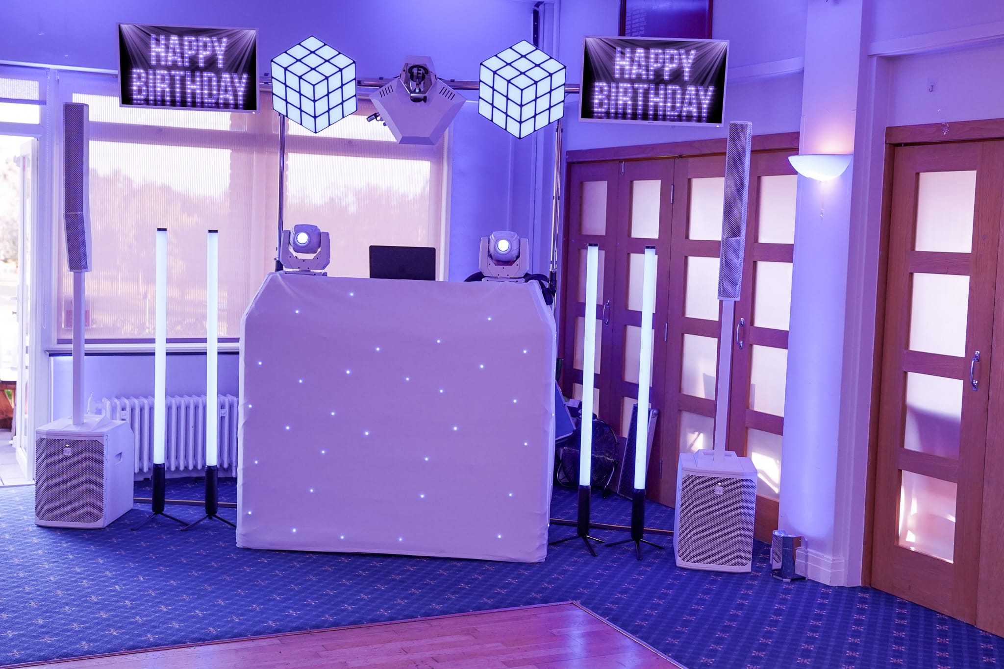Elegant white DJ setup — one of two looks for a 50th birthday disco